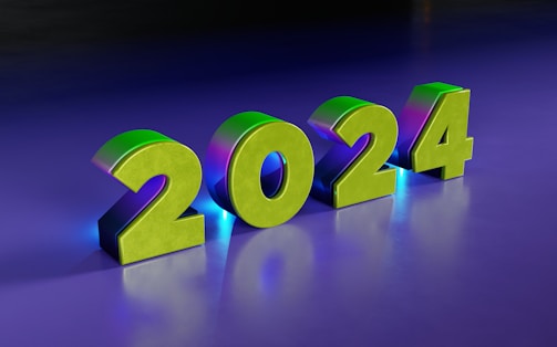 Large, metallic 3D numbers displaying '2024' are set against a smooth, gradient background transitioning from dark purple to a lighter blue. The numbers have a shiny finish with a greenish hue and casts a soft glow.