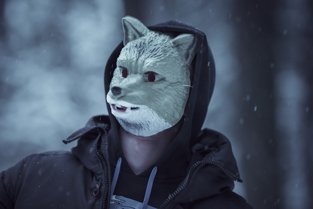 a person wearing a wolf mask in the snow
