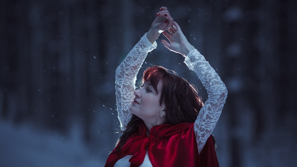 a woman in a red cape and white shirt