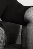 Soft focus shot of delicate silk nightwear draped over a vintage chair.