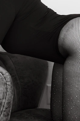 Soft focus shot of delicate silk nightwear draped over a vintage chair.