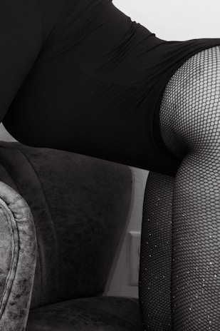 Snapshot of a video paused on a frame featuring pantyhose being carefully unrolled and examined.