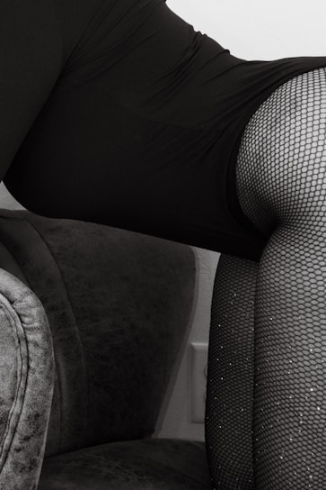 Close-up of a model wearing elegant veinity stockings, highlighting the fine texture and sleek design.