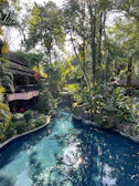 A serene private pool villa at sunset with tropical greenery surrounding it