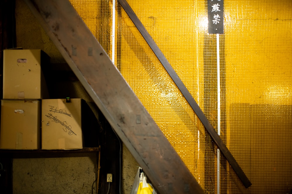 a yellow wall with a wooden stair case