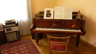 A cozy room with sheet music and a grand piano ready for a lesson.