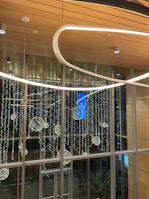 An elegant corporate event space with sleek blue and silver décor and subtle lighting.