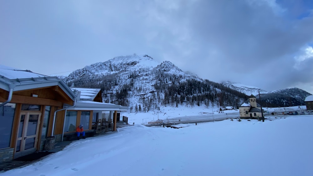 a mountain covered in snow next to a building