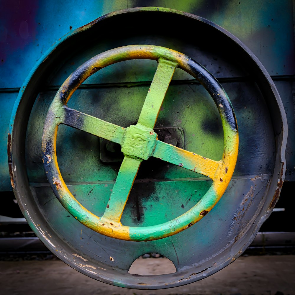 a green and yellow circular object with a cross on it