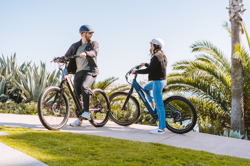 a man and a woman standing next to their bikes