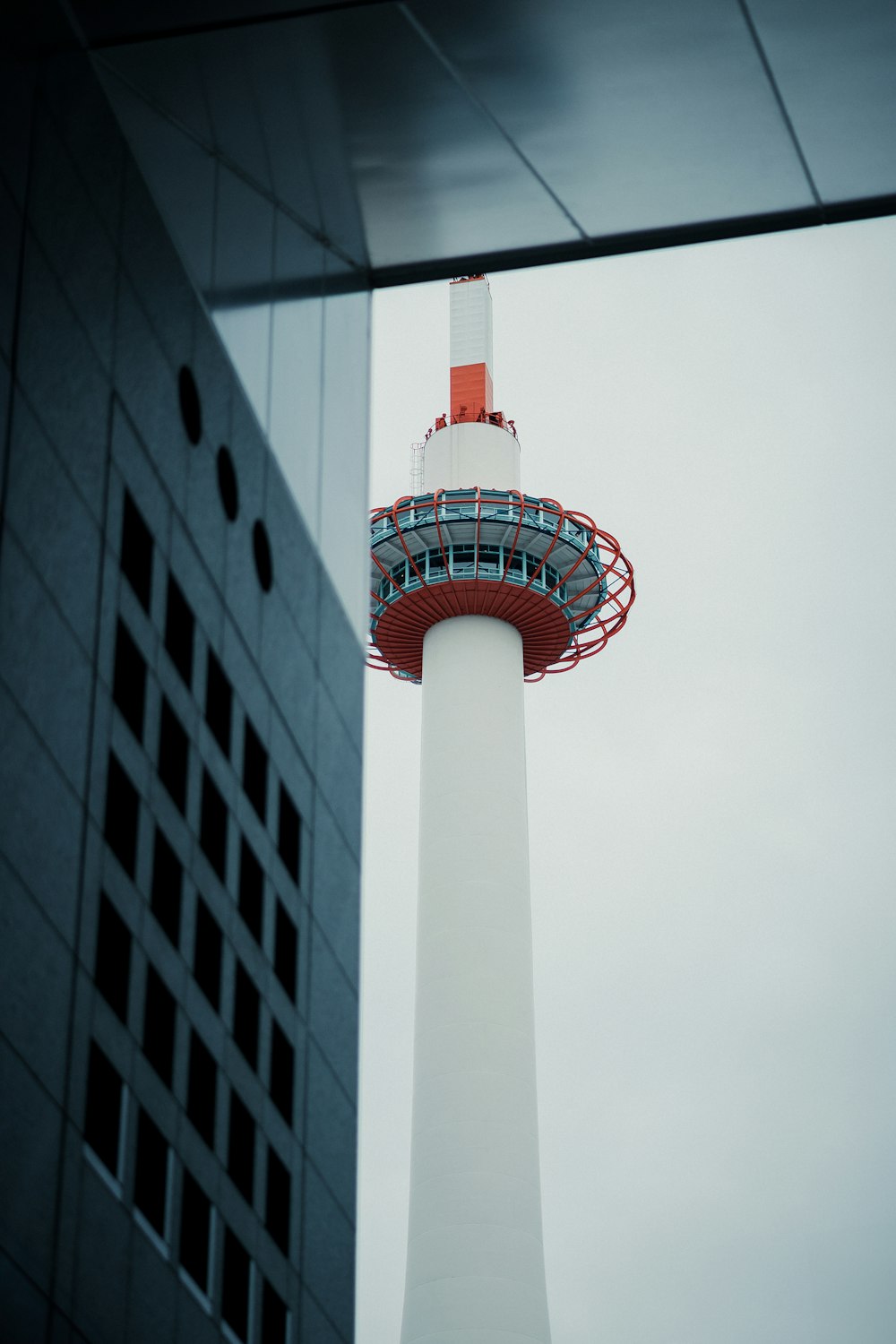 a tall tower with a red and white top