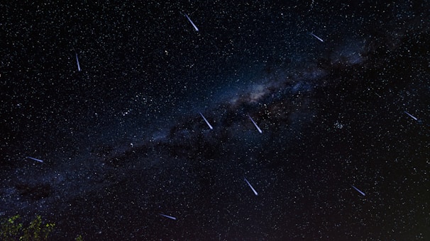 A hauntingly beautiful night sky with stars forming mystical symbols.