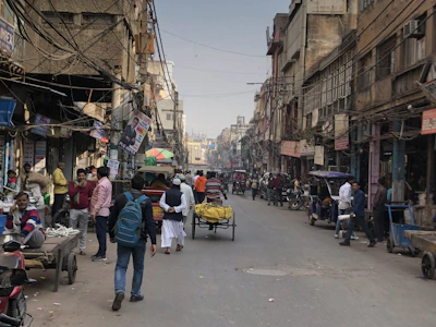 A vibrant street scene in Bihar showing local vendors and daily commuters under the morning sun.