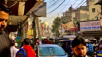 A bustling street in Durgapur with people heading to work and local businesses.