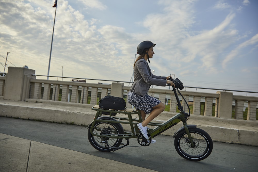 a woman riding a scooter on a bridge