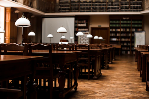 A quiet library corner with open books and a laptop displaying international relations data.