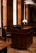 a wooden bar with a lamp on top of it