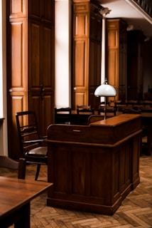 a wooden bar with a lamp on top of it
