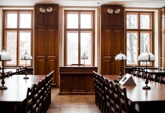 a room filled with lots of wooden tables and chairs