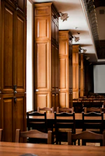 Elegant meeting room with dark wood paneling and soft lighting, evoking confidentiality.