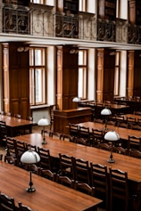 a room filled with lots of wooden tables and chairs
