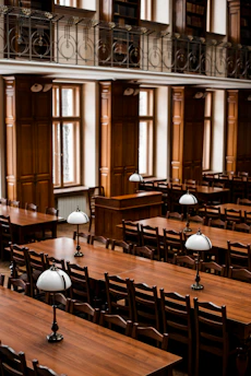 a room filled with lots of wooden tables and chairs
