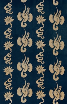 A repeating pattern featuring stylized floral and abstract swirling shapes, arranged vertically on a dark background. The designs have a symmetrical arrangement and give a decorative, intricate appearance.
