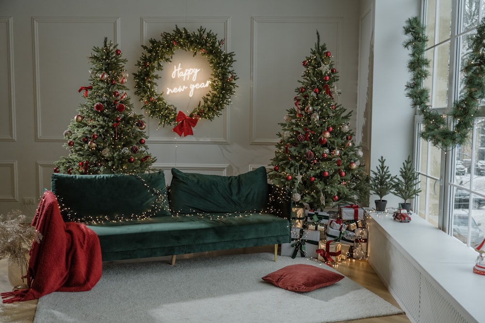 a living room decorated for christmas with wreaths on the wall