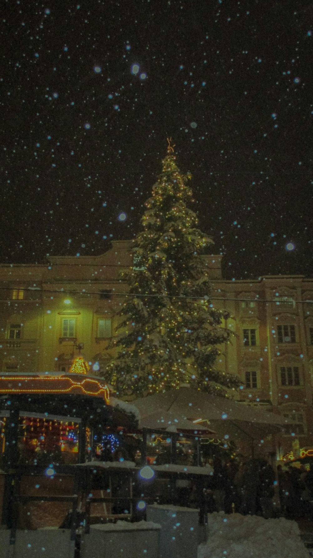 a large christmas tree in front of a building