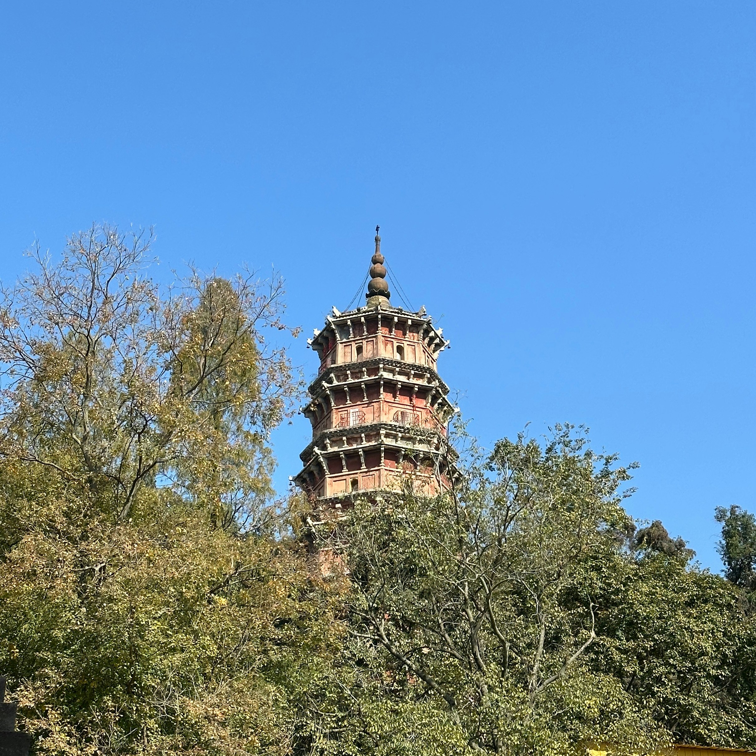 a tall tower with a clock on the top of it
