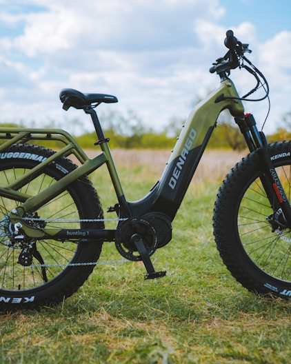 a bike parked in the grass on a sunny day