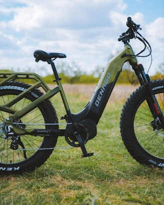a bike parked in the grass on a sunny day