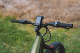 Close-up of a modern electric scooter’s handlebar and display panel.