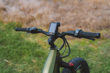 Close-up of a royal electra electric bike’s futuristic dashboard and handlebar controls.