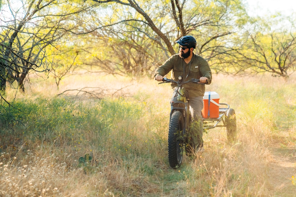 a man riding a dirt bike through a field