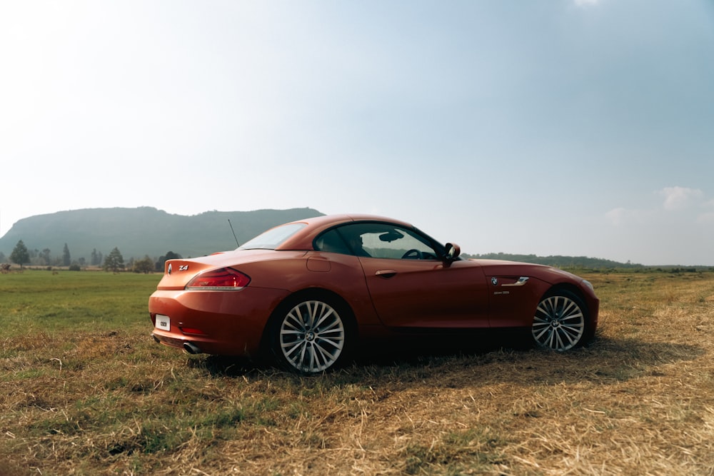 a red sports car parked in a field