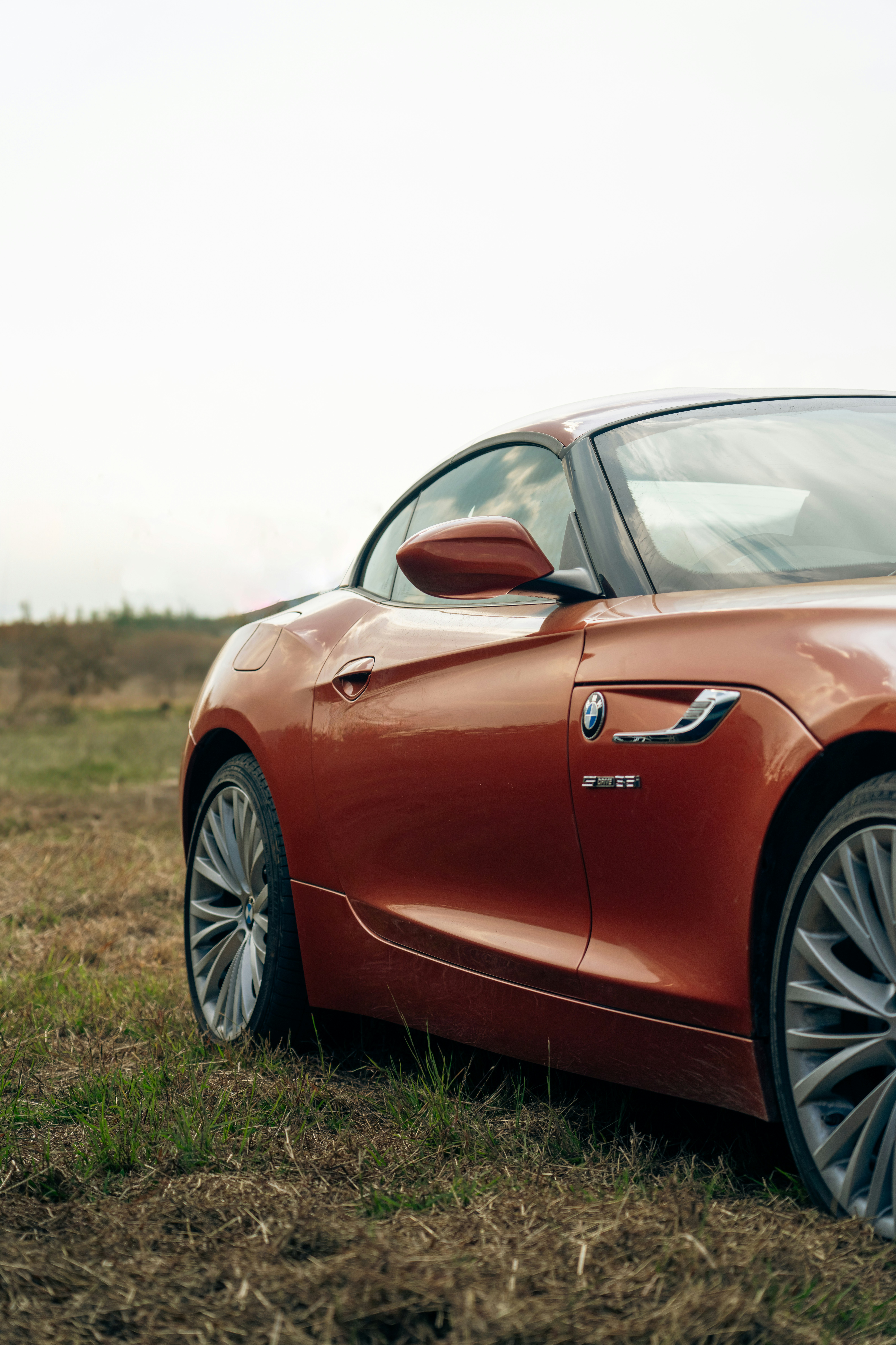 a red sports car parked in a field