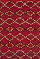 a red and yellow rug with a diamond pattern
