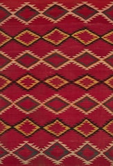 a red and yellow rug with a diamond pattern