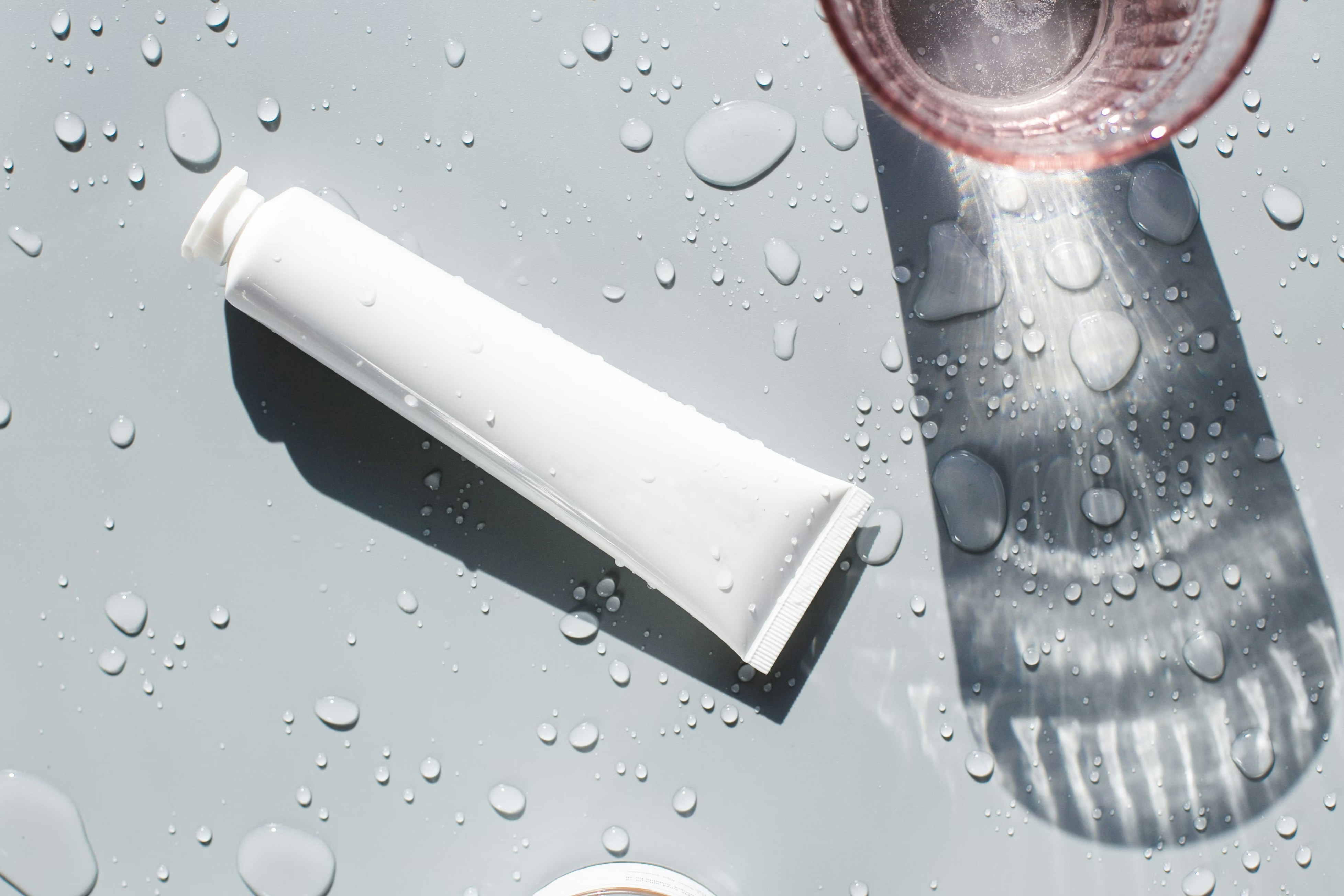 a cup of coffee next to a tube of toothpaste