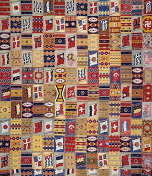 A vibrant quilt made from colorful company shirts, each square representing a different employee's journey.