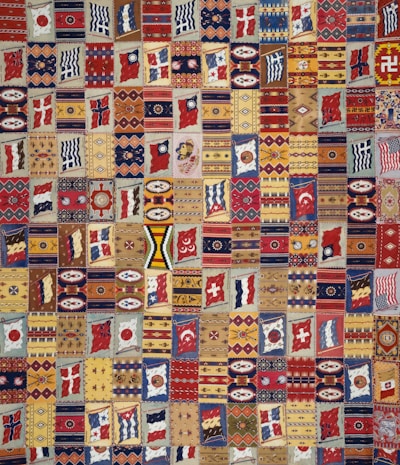 A close-up of a vibrant custom signature quilt with heartfelt guest messages in colorful ink on fabric squares.