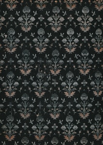 A dark, intricately patterned wallpaper featuring symmetrical floral designs. The repeating motifs include stylized flowers and leaves, along with subtle butterfly shapes, all rendered in muted shades of green, white, and orange.