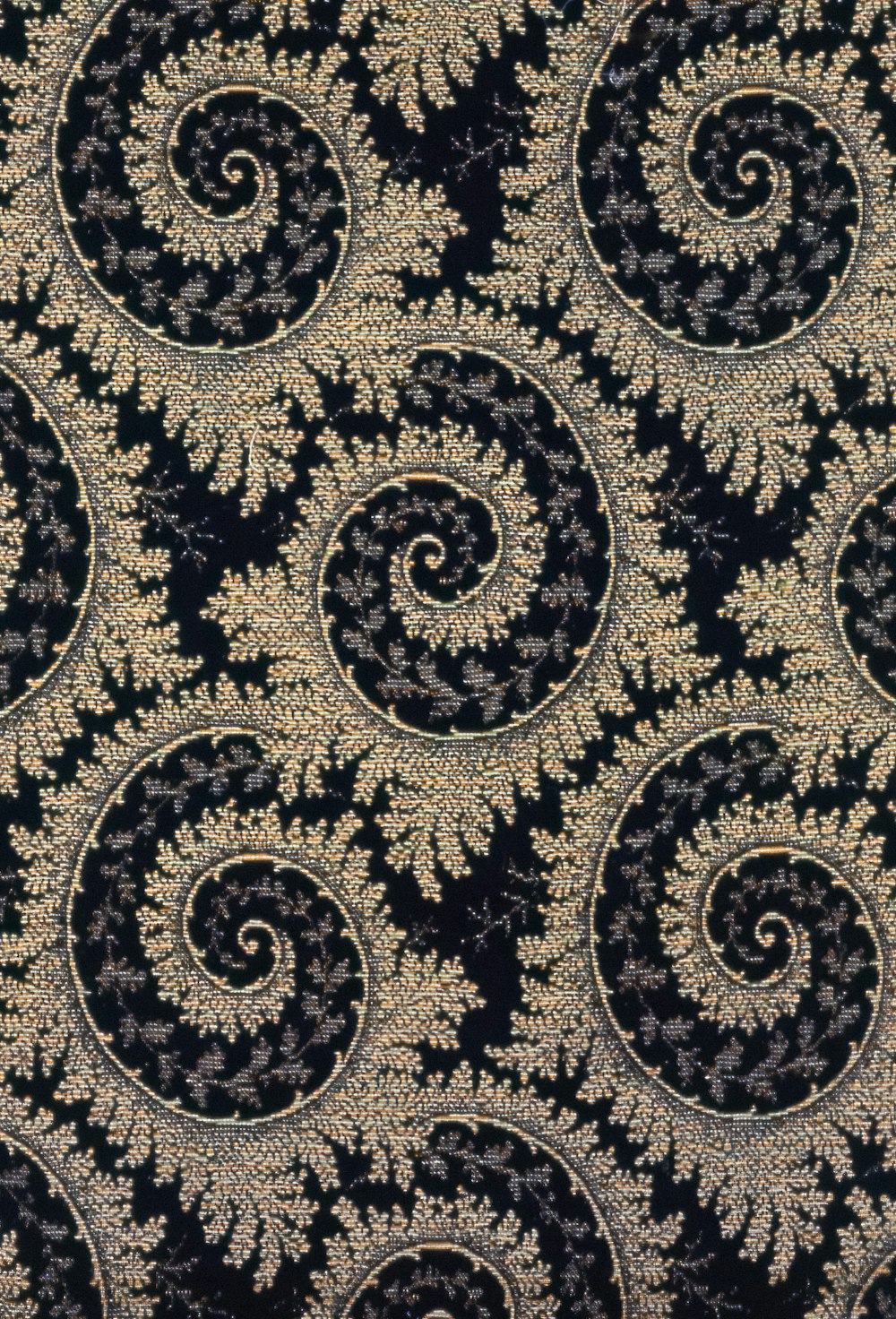 a close up of a black and gold wallpaper