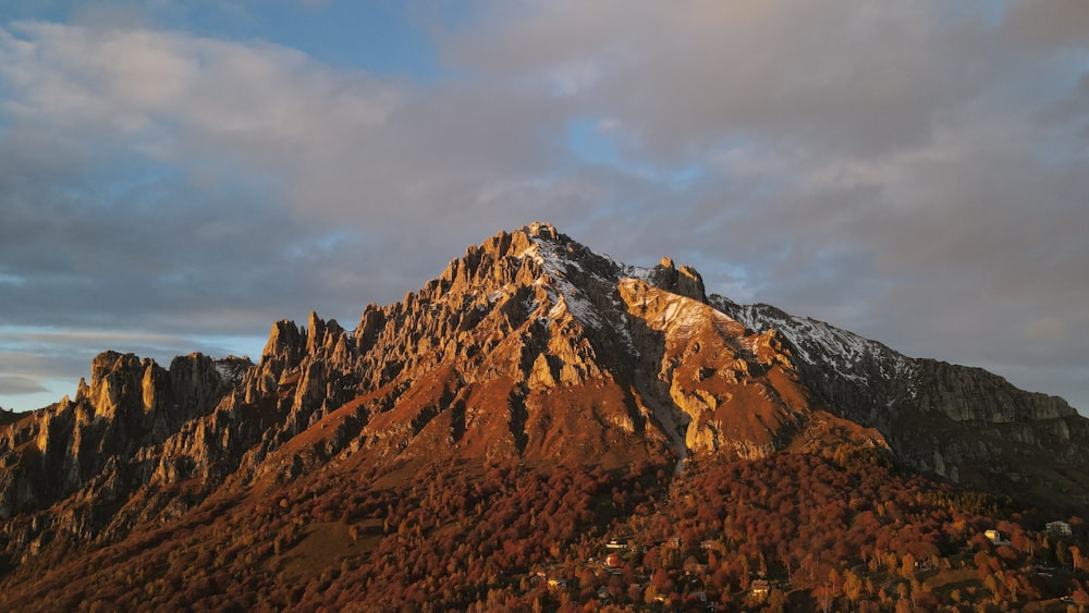 a very tall mountain with a sky in the background