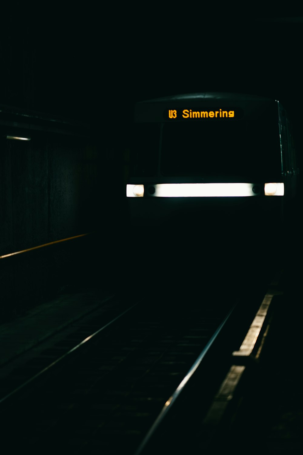 a train traveling down train tracks at night