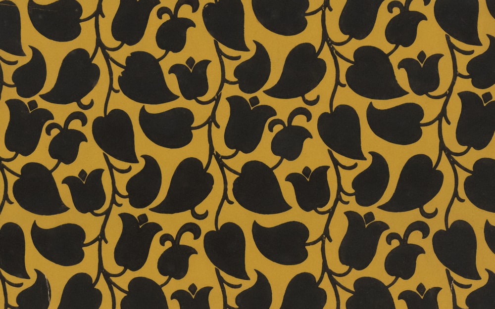 a black and yellow pattern with black leaves