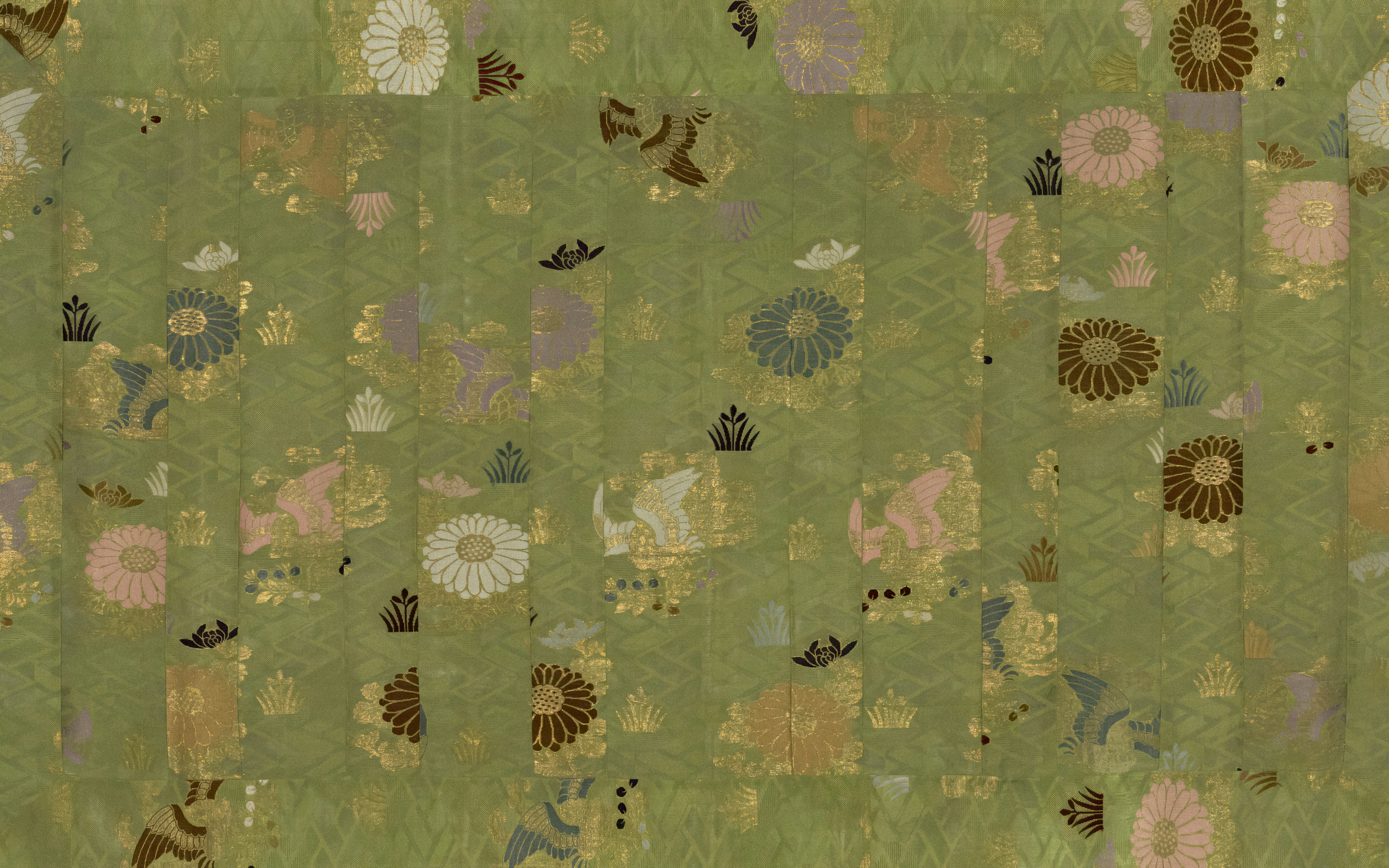 a patchwork quilt with animals and flowers on a green background