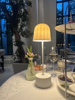 Evening ambiance with a softly lit device displaying dessert specials next to a candle.