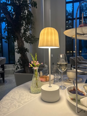 Evening ambiance with a PromesaOptima device glowing softly on a table during a restaurant event.